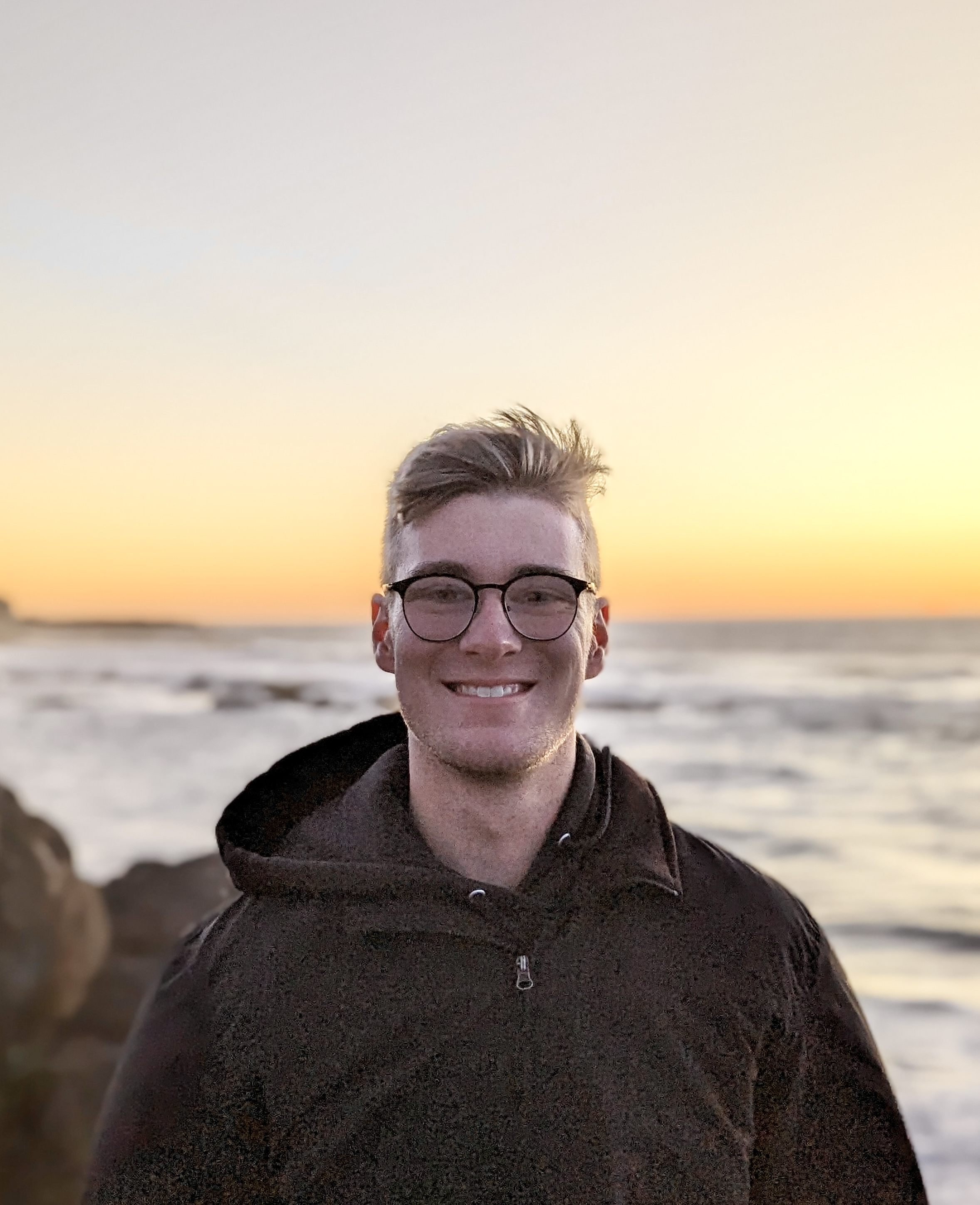 Chris smiling at a piano